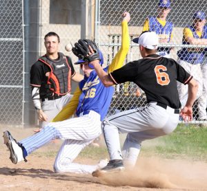 Iola-Scandinavia catcher Cam Gruenwald could not get the ball to Seth Korb in time to tag Trevor Pederson as he slides into home plate.  Holly Neumann Photo