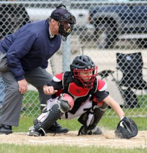 Manawa's Nate Reynolds gets his glove in the dirt to stop the ball behind the plate.  Holly Neumann photo.