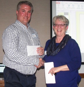 New London High School science teacher John Ruckdashel accepts a donation presented by Tracy Koenig from Wild Ones of the Fox Valley Area on Thursday, March 31, in Oshkosh.  Submitted photo
