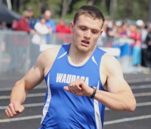 Waupaca's Mitchell Rotta checks his time after winning the boys' 1,600-meter run April 23 at the Waupaca County Meet at Waupaca High School. He also won the 3,200-meter run to help the Comets win the boys' championship at the annual meet. Greg Seubert Photo