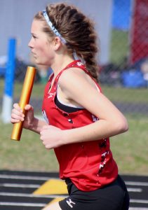 Abby Wheaton carries the baton for Weyauwega-Fremont's girls' 3,200-meter relay team. She ran the second leg of the relay, which finished fifth. The Indians went on to win the girls' championship at the Wauupaca County Meet at Waupaca High School. Greg Seubert Photo