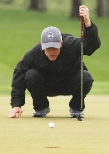 Ryan Schuelke of Manawa eyes up his shot on the ninth green at Glacier Woods Golf Club in Iola May 10. Schuelke tied Iola-Scandinavia's Zach Mortenson for the low round of the Central Wisconsin Conference meet, as both golfers carded an 80. Holly Neumann Photo Holly Neumann photo.