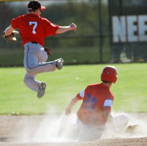 Hortonville senior Braden Van Camp (20) slides to a base as Neenah's Brandon Beauchamp leaps for the ball on May 17.  Submitted photo