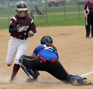 Fox Valley Lutheran's Samantha Birling avoids the tag of Waupaca Markie Ash to score an inside-the-park home run for the Foxes. Greg Seubert Photo