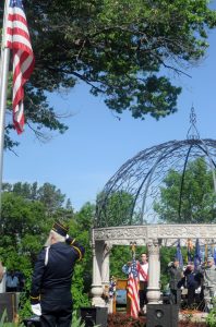 Veterans salute the American flag as New London High School vocalist Matt Schuler leads the singing of the national anthem at Floral Hill Cemetery in New London on Monday, May 30.  Scott Bellile photo