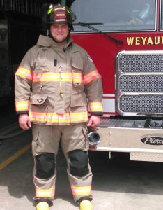 Weyauwega Firefighter Casey Schalkowski models the new turnout gear.  Submitted Photo