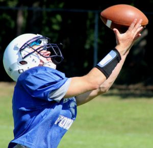 A wide receiver reaches to catch the ball while working out with quarterbacks at practice at Waupaca High School. The Comets will open the season with road games at Green Bay East and Green Bay West before hosting New London at 7 p.m. Friday, Sept. 2, at Haberkorn Field for hte home opener. Greg Seubert