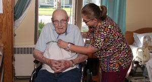 Nurse Clarissa Chapman (left), tends to resident Robert Douglas at Iola Living Assistance. Submitted Photo