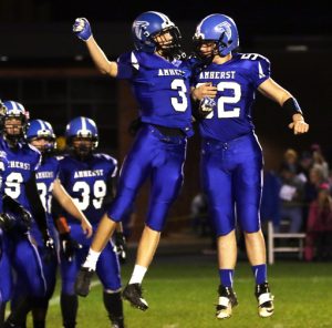 Marcus Glodowski and Bryce Holderman get in a chest bump while being introduced as Amherst starters before the Falcons' playoff game with Winnebago Lutheran. Holly Neumann Photo