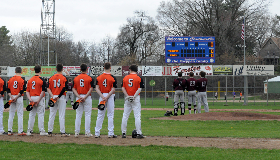 Clintonville High School baseball players standing at attention during the national anthem at W.A. Olen Athletic Field