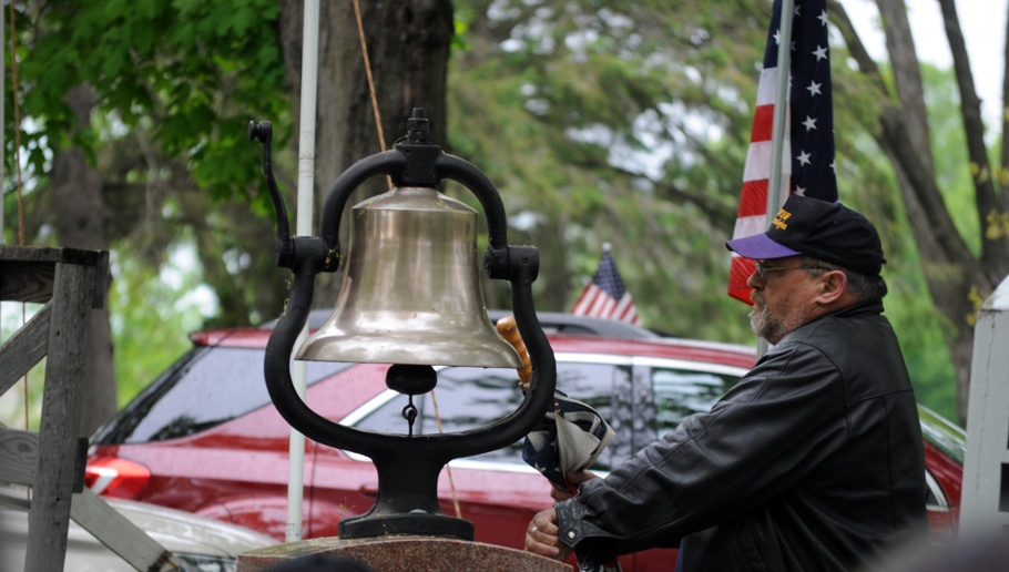 The bell is rang as Richard Beggs reads off names of deceased military members.