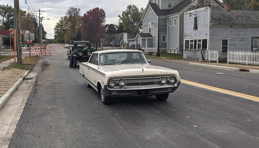 A parade of vintage vehicles try out Iola's new Main Street bridge.